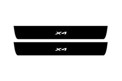 Catalog illustration of two black front door sill plates with X4 lettering.