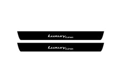 Catalog illustration of two black front door sill plates with Luxury Line lettering.