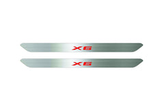 Catalog illustration of two narrow silver door sill inserts with red X6 lettering on a white background.