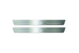 Two long silver-finished door sill plates with X7 lettering on a light background, straight-on view.