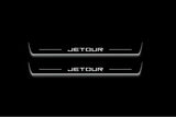 Two long door sill plates with Jetour lettering and edges illuminated in white, straight-on view on a dark background.