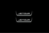 Two short door sill plates with Jetour lettering and edges illuminated in white, straight-on view on a dark background.
