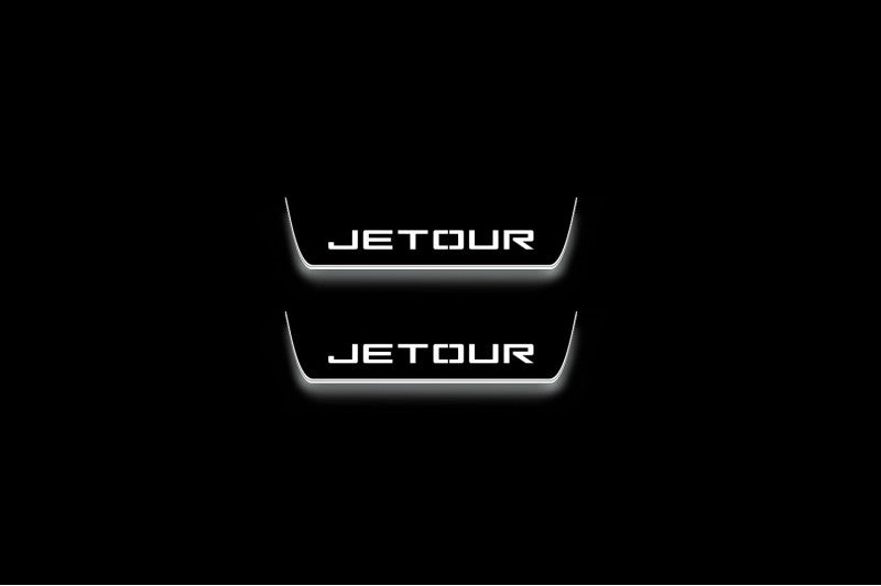 Two short door sill plates with Jetour lettering and edges illuminated in white, straight-on view on a dark background.