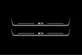 Two long door sill plates with XV lettering and edges illuminated in white, straight-on view on a dark background.