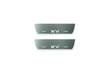Two short silver-finished door sill plates with XV lettering on a light background, straight-on view.