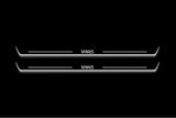Two long door sill plates with Yaris lettering and edges illuminated in white, straight-on view on a dark background.