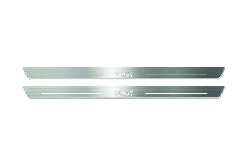Two long silver-finished door sill plates with Yaris lettering on a light background, straight-on view.