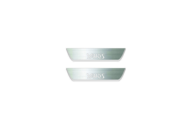 Two short silver-finished door sill plates with Yaris lettering on a light background, straight-on view.