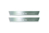 Two long silver-finished door sill plates with Yeti lettering on a light background, straight-on view.