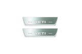Two short silver-finished door sill plates with Yeti lettering on a light background, straight-on view.