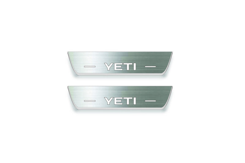 Two short silver-finished door sill plates with Yeti lettering on a light background, straight-on view.
