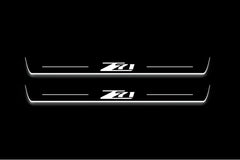 Two long door sill plates with Z71 lettering and edges illuminated in white, straight-on view on a dark background.