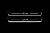 Two long door sill plates with Zafira lettering and edges illuminated in white, straight-on view on a dark background.