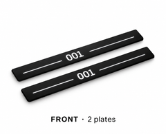 Matte PRO catalogue illustration: two flat black FRONT plates with illuminated 001 lettering and top lines on white; not exact vehicle dimensions
