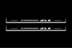Two long door sill plates with Camaro ZL1 lettering and edges illuminated in white, straight-on view on a dark background.
