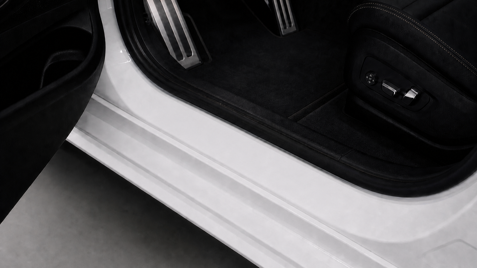 Original painted-metal vehicle threshold before an illuminated sill is added